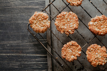 Healthy vegan oat cookies on a cooling rack on the scratch wooden table