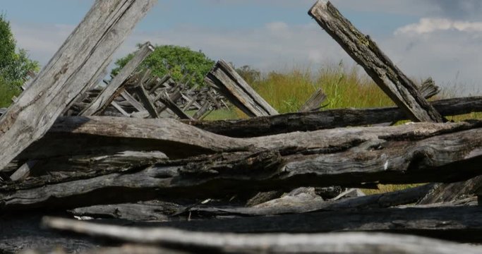 Civil War Time Split Rail Fence with Grass Field Slow Tilt Up, 4K