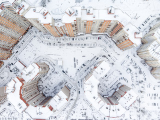 Fototapeta premium Top view at the dwelling district with snow covered inner yards and lot of parked cars. Winter season. St. Petersburg, Russia.