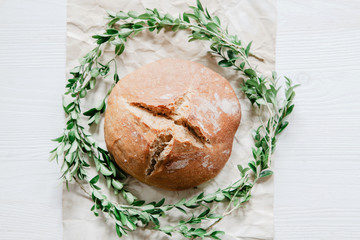 Easter bread with boxwood on rustic wooden background