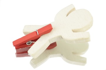 Wooden male with red clothespin on the legs