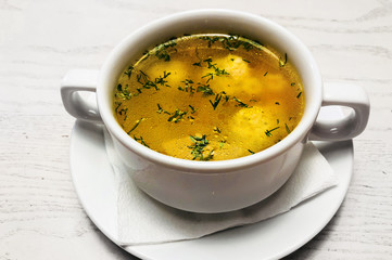 Chicken hot broth in white soup tureen