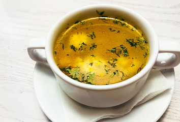 Chicken hot broth in white soup tureen