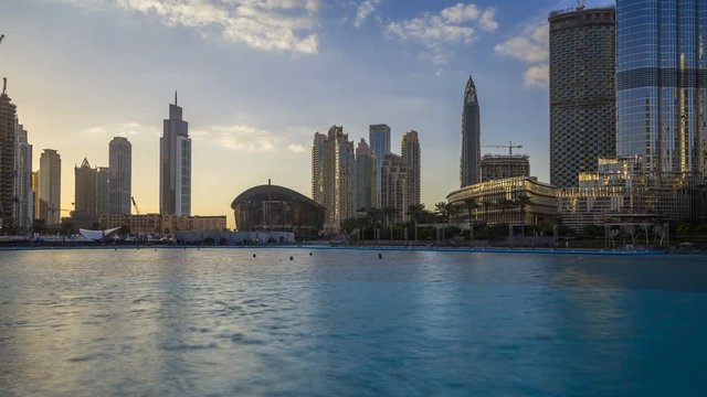 Timelapse of downtown Dubai skyline, view from the Dubai fountain to the Opera Theatre. Modern city cityscape with skyscrapers. Dubai, UAE.