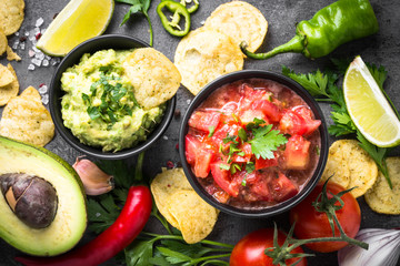 Latinamerican food party sauce guacamole, salsa, chips.