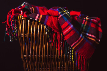 Red Flannel Throw Blanket Draped in Wicker Basket