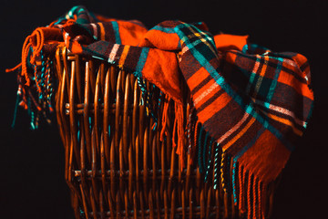 Orange Flannel Throw Blanket Draped in Wicker Basket