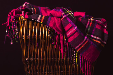 Purple Flannel Throw Blanket Draped in Wicker Basket