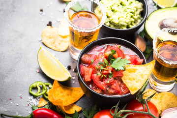 Latinamerican food party sauce guacamole, salsa, chips and tequi