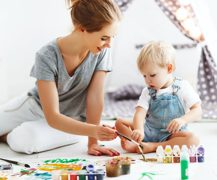 children creativity. mother and baby son drawing together