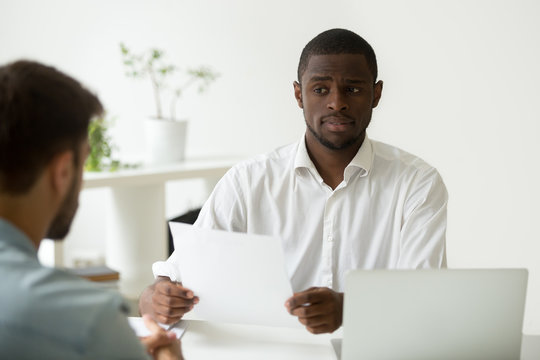 African american hr manager looking doubtful about hiring incompetent candidate, uncertain distrustful black employer skeptical about applicant cv, bad resume failed job interview performance concept