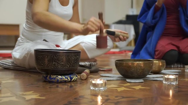 Women meditate and do yoga. The Tibetan singing bowls. Master class for creative group