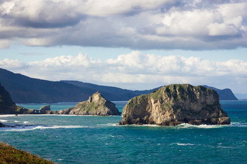San Juan de Gaztelugatxe iconic chapel on the background from Cape Matxitxako on cloudy day in Basque Country coast