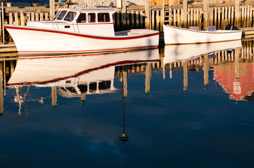 Fototapeta na wymiar White Boats Alongside Wharf