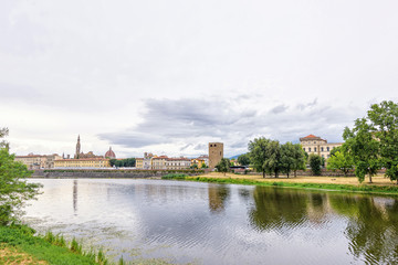 Fototapeta na wymiar Daylight cloudy day view to Arno river with reflections