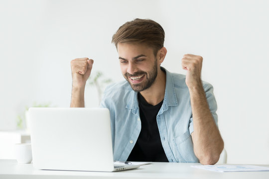 Happy excited man celebrating online win success achievement result looking at laptop screen, successful entrepreneur excited by good news in email, motivated by business win or new job opportunity
