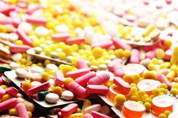 Pink medicine pills and colorful blisters pack