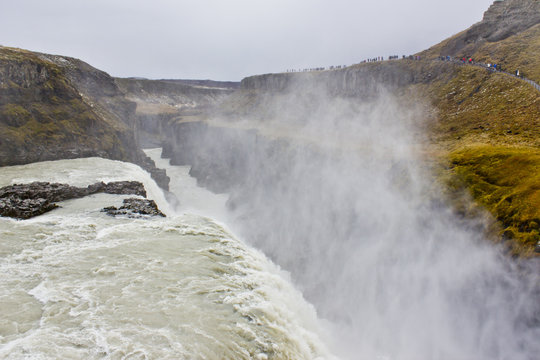 Looking over the Edge with Mist Rising Up Gullfoss Waterfall in Iceland