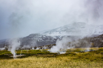 Steam Rising from the Strokkur Geysir Field with Mountains in the Background
