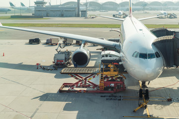 Loading cargo on plane in airport before flight.