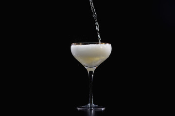 pouring a glass of sparkling wine