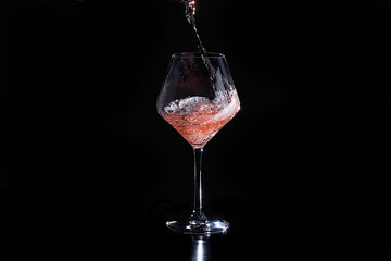 Pouring a glass of rose wine 