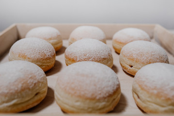 Donuts on plate on woode board