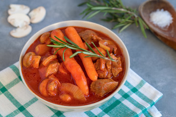 Spicy turkey goulash with mushrooms and carrots in tomato sauce.