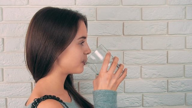The girl is drinking water.
