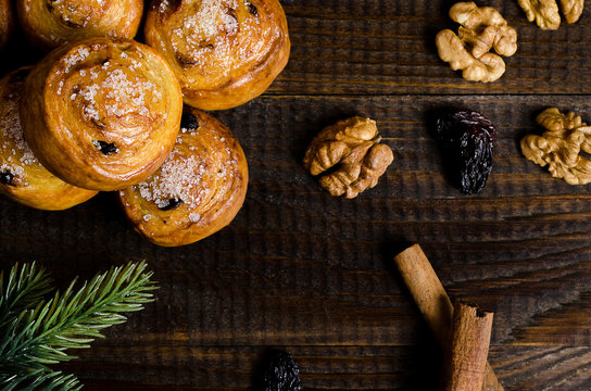 homemade cookies with sugar and walnuts, on a dark wooden background with a spruce branch