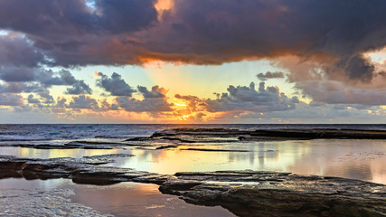 Fototapeta na wymiar Overcast and Cloudy Sunrise Seascape