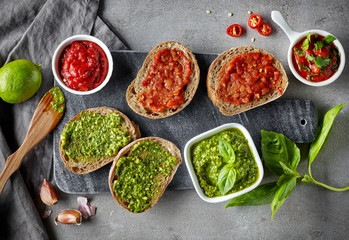Bread slices with basil pesto and garlic tomato sauce