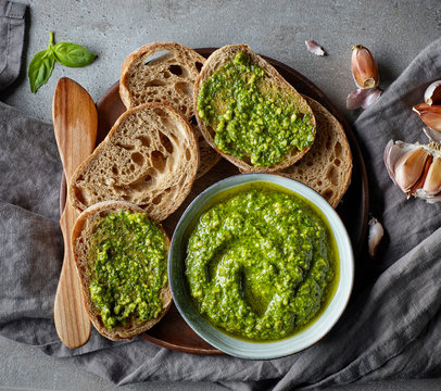 Fototapeta Bowl of basil pesto on grey table