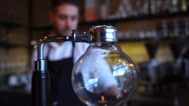 Close up of Syphon coffee maker barista in a background