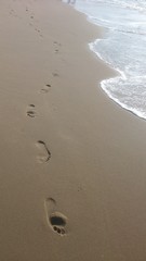 Footsteps in the sand at the coast