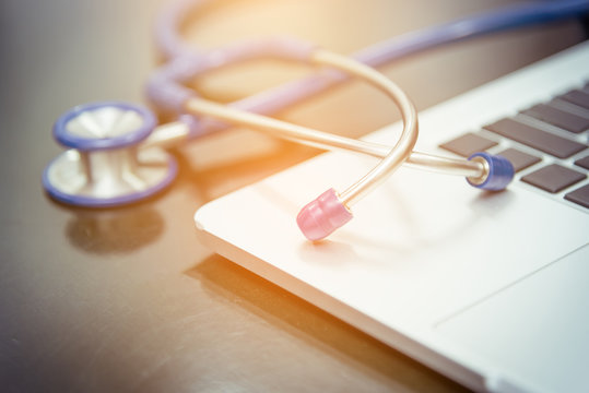 Stethoscope , x-ray film and laptop . Computer technology is an integral part of medicine, health care and medical insurance .selective focus and medical concept