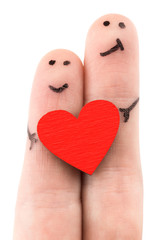 family concept - a man and a woman hold on the red heart, painted at fingers and isolated on white...