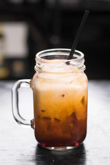 THai Iced Tea in mason jar, dark background