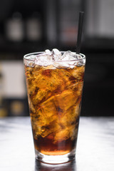 Iced Cola in tall glass, dark background