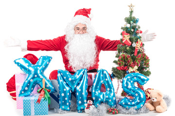 Santa Claus  with big bag delivery christmas boxes gifts and decoration item .He pointing in blank sign, isolated on white background .copy space for Advertising christmas and happy new year festival