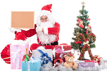 Santa Claus  with big bag delivery christmas boxes gifts and decoration item .He pointing in blank sign, isolated on white background .copy space for Advertising christmas and happy new year festival