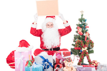 Santa Claus  with big bag delivery christmas boxes gifts and decoration item .He pointing in blank sign, isolated on white background .copy space for Advertising christmas and happy new year festival