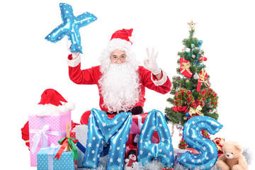 Santa Claus  with big bag delivery christmas boxes gifts and decoration item .He pointing in blank sign, isolated on white background .copy space for Advertising christmas and happy new year festival