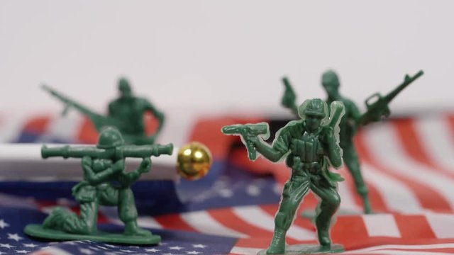 Military imagery toy soldiers on american flag