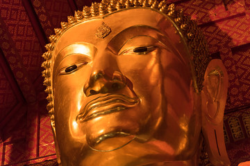 Closed up of The face of gold Buddha. The big gold Buddha statue face close up at wat phanan choeng...