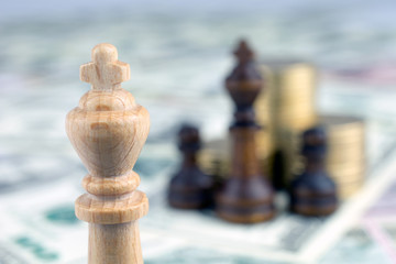 chess pieces piles of gold coins crisis intervention concept