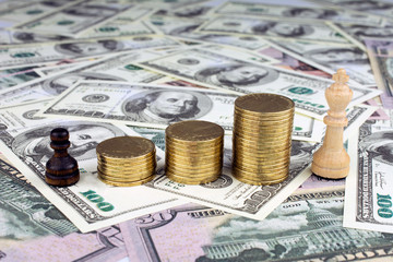 chess pieces piles of gold coins conflict management concept