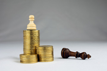 chess pieces piles of gold coins crisis intervention concept