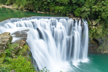 Fototapeta premium Shifen Waterfall ,Beautiful big waterfall in Pingxi district, New Taipei City, Taiwan.Travel Famous natural landmark in Taiwan . Long Exposure