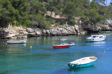 Fototapeta na wymiar Europe, Spain, Balearic Islands, Mallorca, Santanyi, Cala Figuera . A small , colorful fishing harbor on S.E. corner of island. Sailboat anchoring.